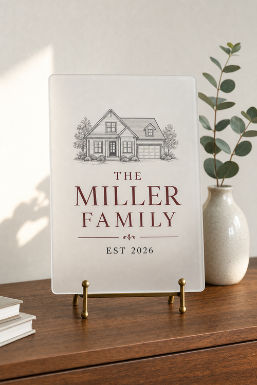 Personalized frosted acrylic welcome plaque with family name and house illustration on a brass easel — placeholder image