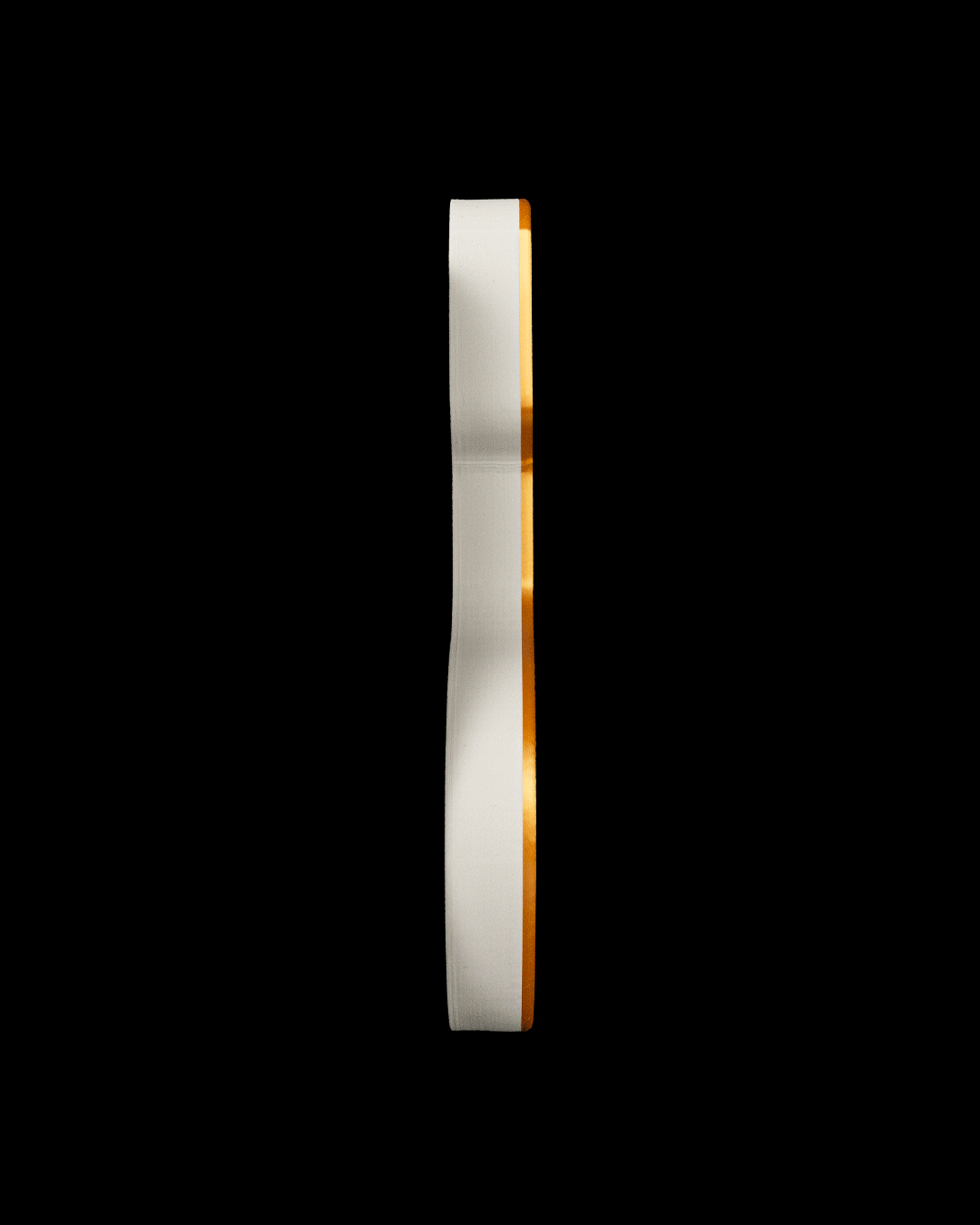 Edge view of the stocking tray showing its low profile, on a black background