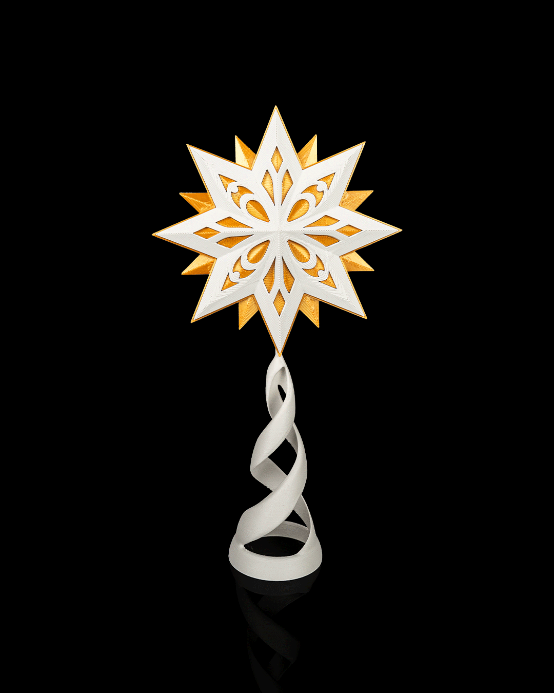 White geometric star tree topper with a gold middle layer on a white spiral stand, matte, on a black background