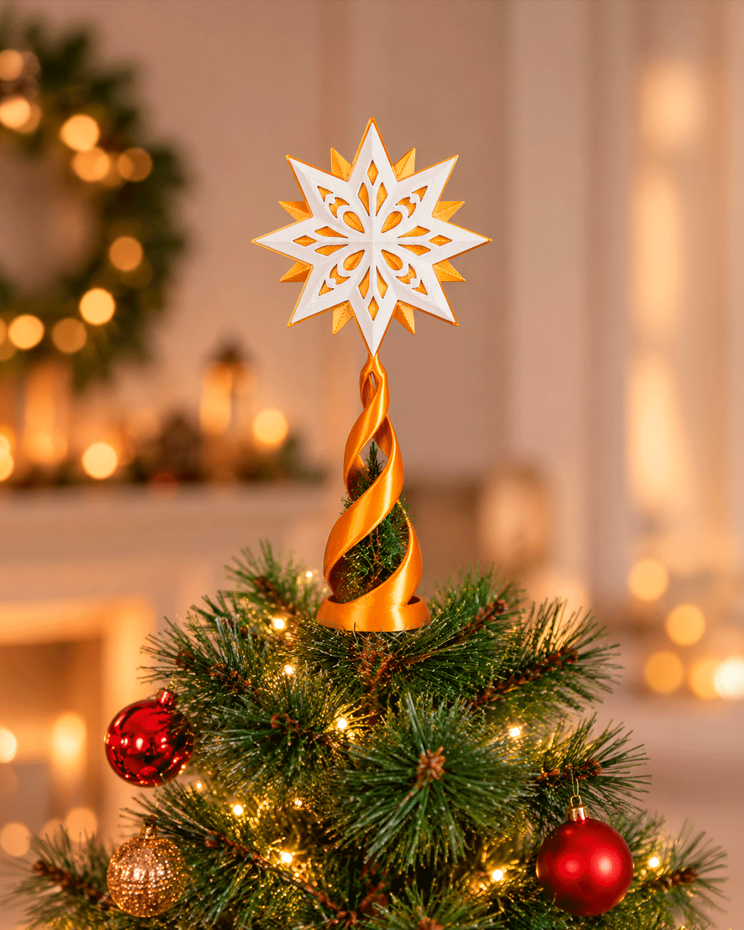 Custom colorway example: white and gold star topper on a gold spiral stand, on top of a lit Christmas tree