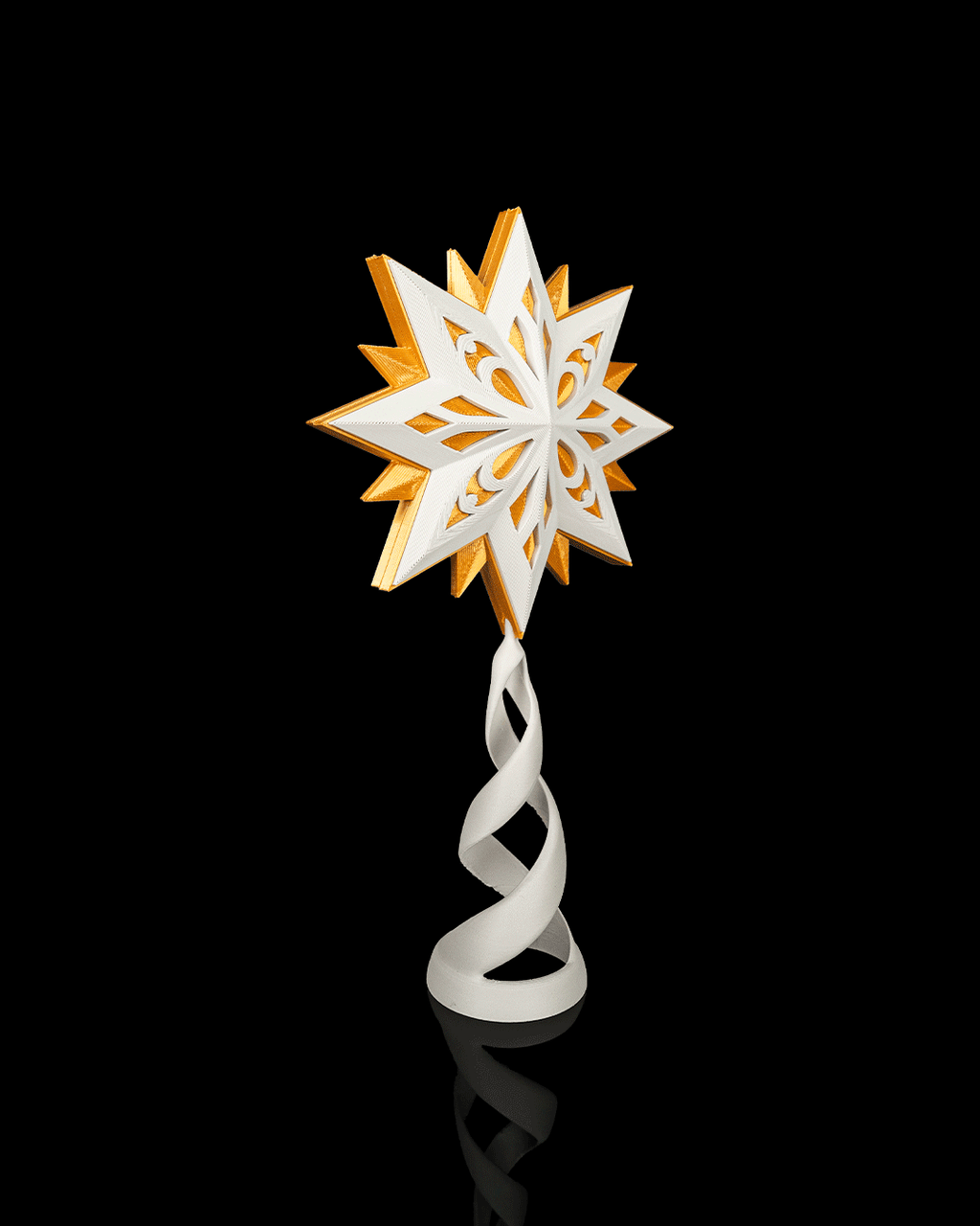 Angled view of the white and gold star topper on its white spiral stand, on a black background