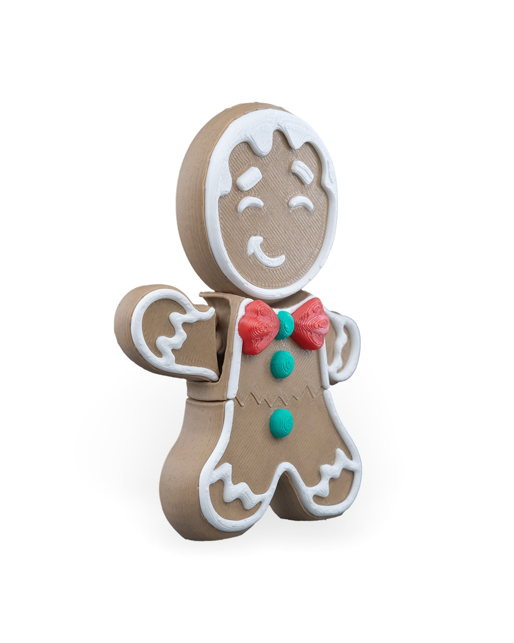 Gingerbread man Christmas ornament angled to the left, showing the icing trim and red bow tie, on a white background