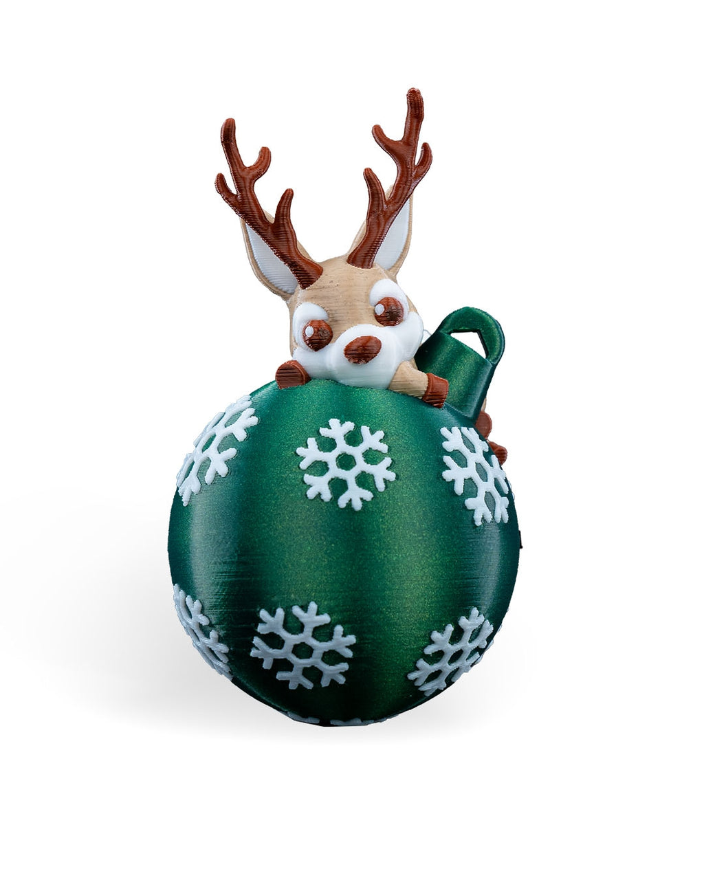 Lying Reindeer Christmas ornament, 3D printed, front view: tan reindeer with brown antlers lying on a green ball with white snowflakes, on a white background