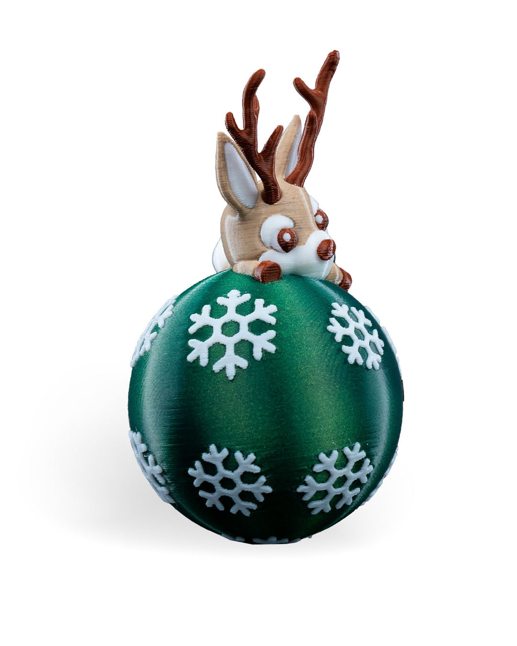 Lying Reindeer Christmas ornament seen from the front at a slight angle, showing the reindeer's face and antlers, on a white background