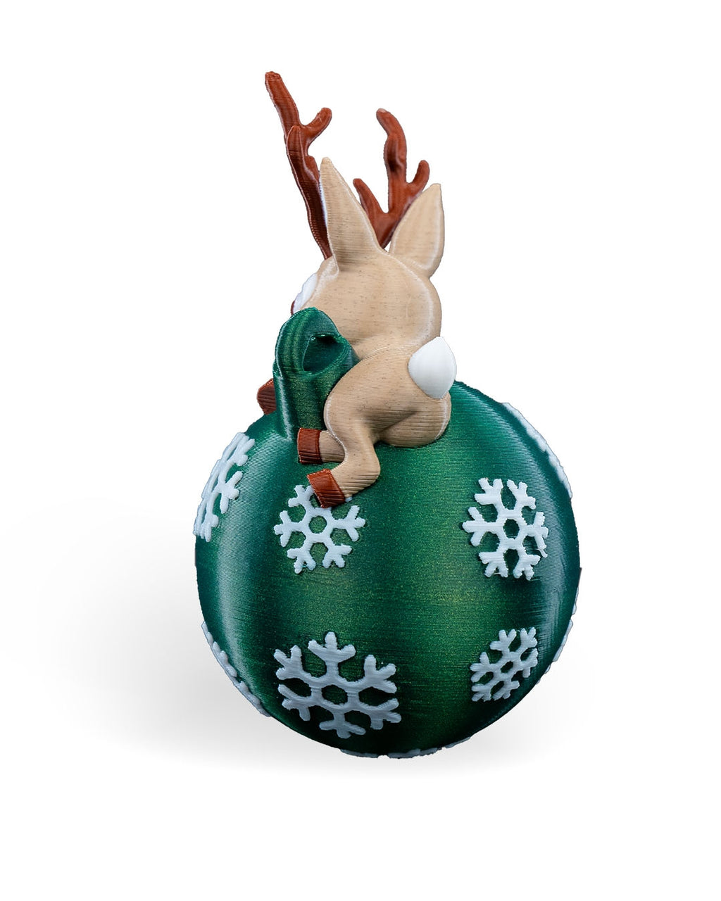 Lying Reindeer Christmas ornament angled from the back, showing the antlers, tail and snowflake ball, on a white background