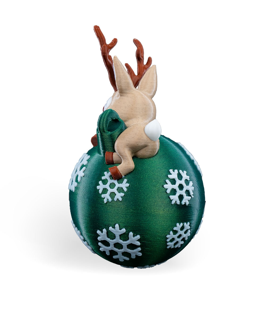 Lying Reindeer Christmas ornament angled from the back, showing the antlers, tail and snowflake ball, on a white background