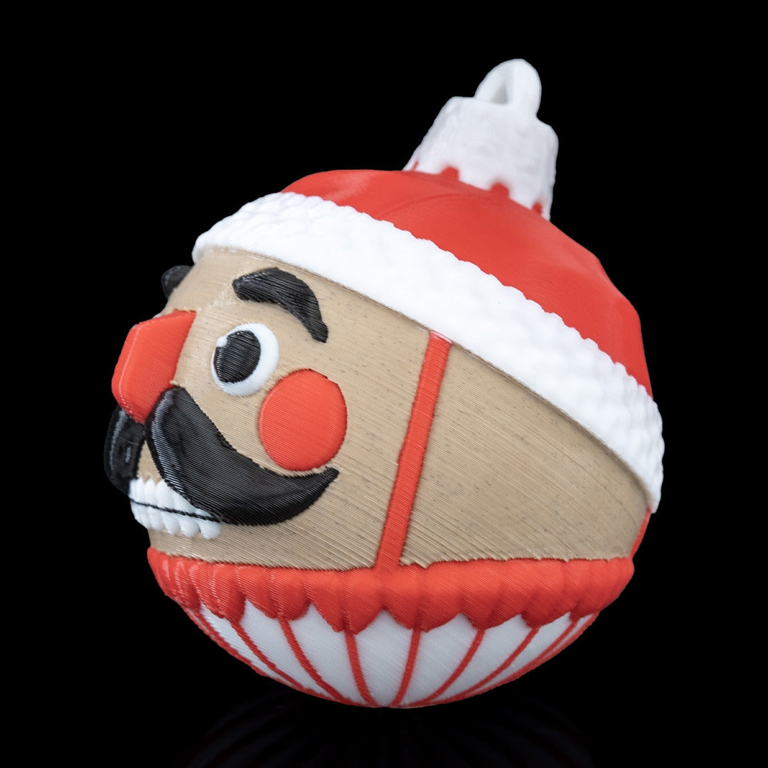 Side profile of the Nutcracker Christmas ornament with red hat, white trim and printed top loop, on a black background