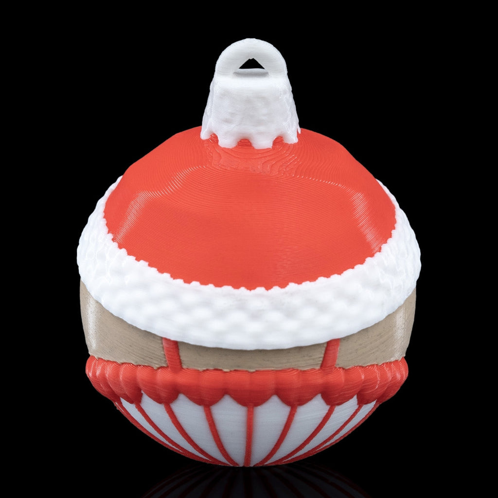 Back of the Nutcracker Christmas ornament with red hat, white fur trim and printed hanging loop, on a black background