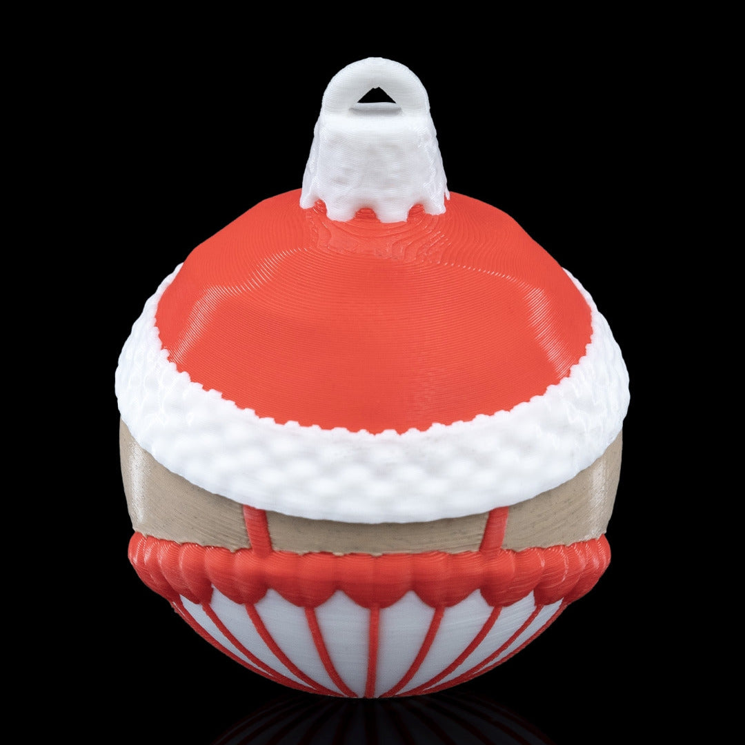 Back of the Nutcracker Christmas ornament with red hat, white fur trim and printed hanging loop, on a black background