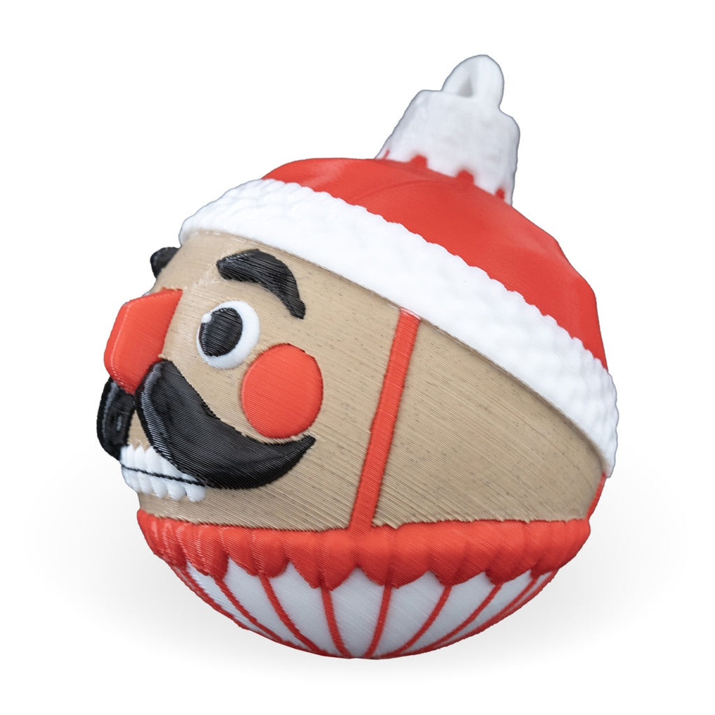 Side profile of the Nutcracker Christmas ornament with red nose, red hat and printed top loop, on a white background