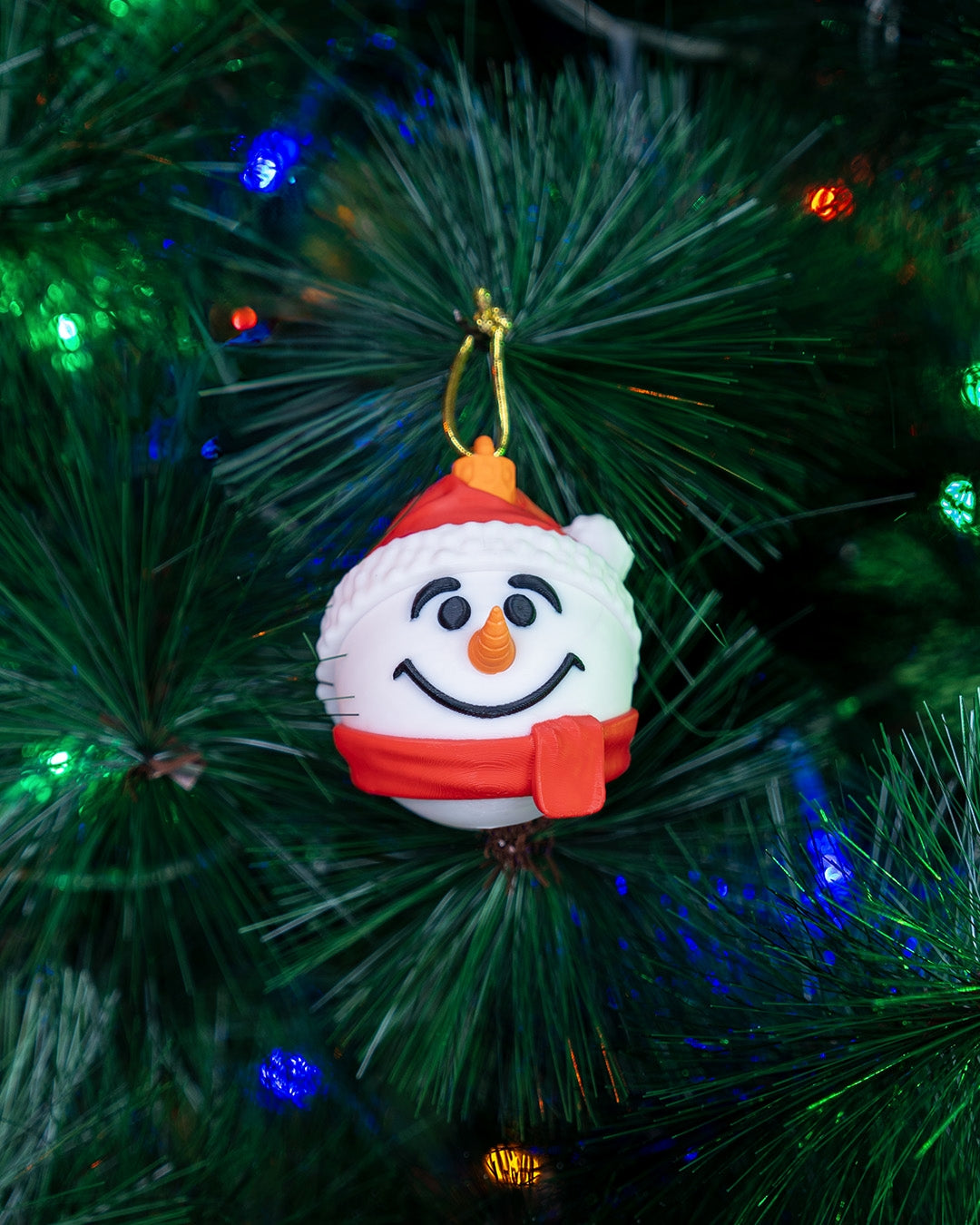 Nutcracker & Snowman Ornament 2-Pack: snowman Christmas ornament hanging on a lit Christmas tree