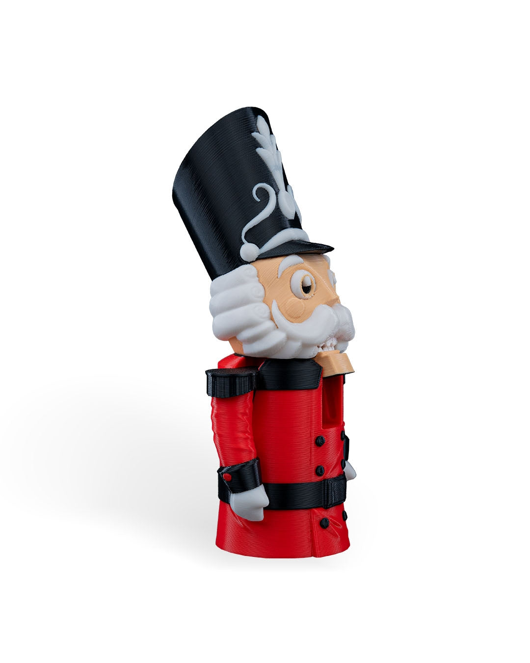 Nutcracker Soldier Christmas ornament angled to the right, showing the tall hat, beard and red coat, on a white background