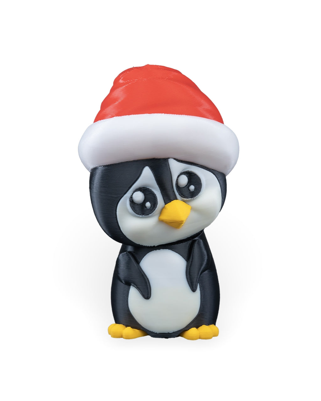 Penguin in Santa Hat Christmas ornament, 3D printed, front view: black and white penguin in a red Santa hat with yellow beak and feet, on a white background