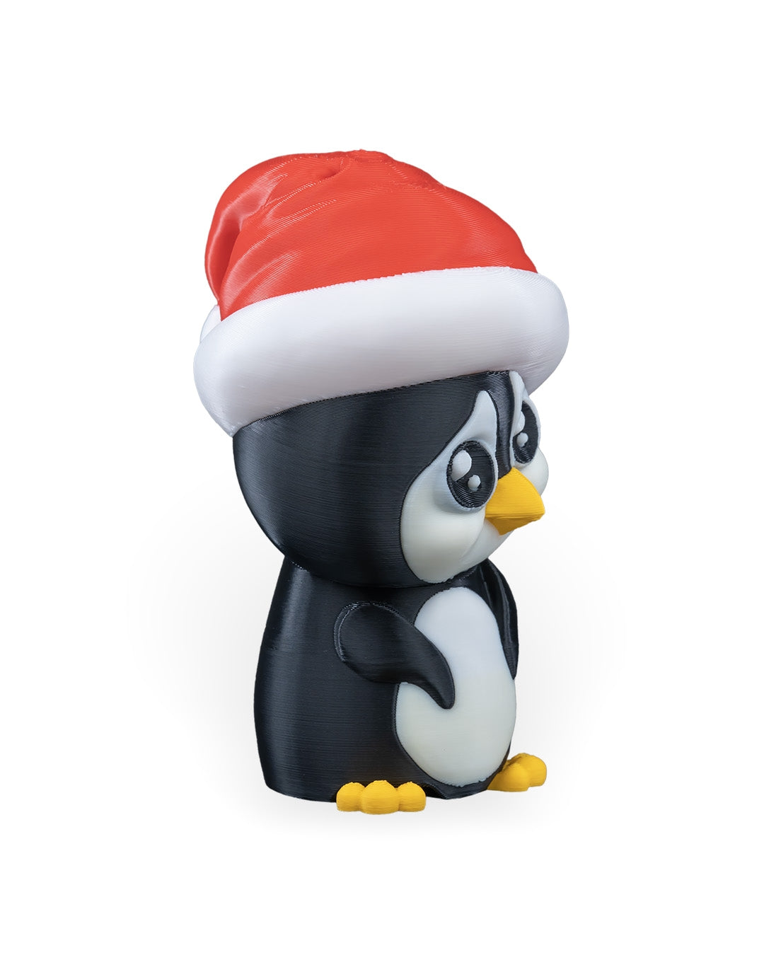 Penguin in Santa Hat Christmas ornament angled to the right, showing the white belly and yellow feet, on a white background