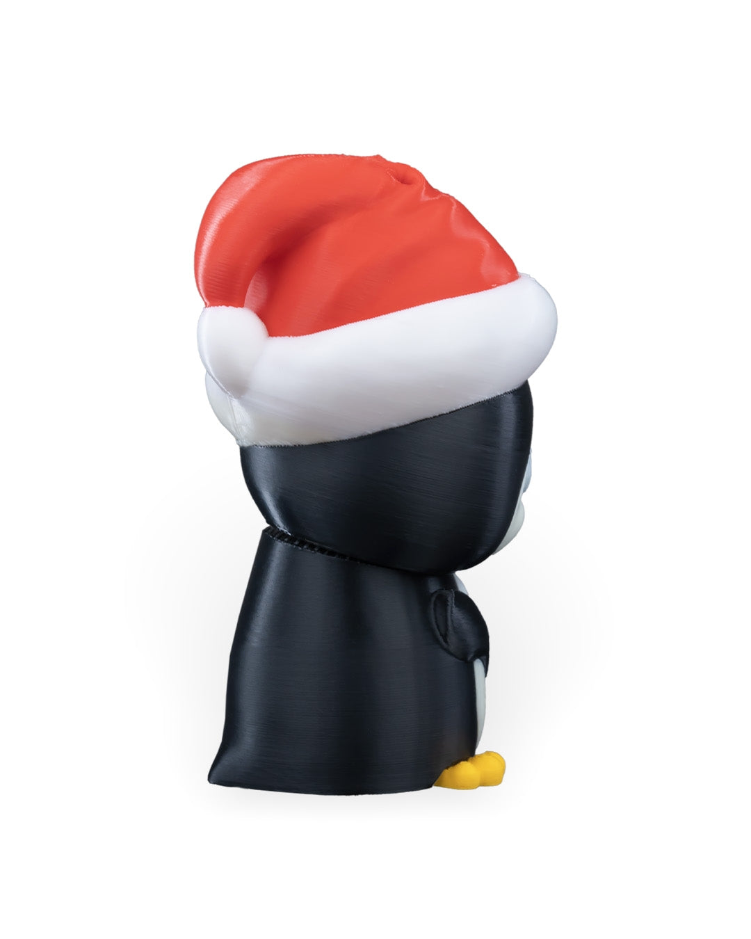 Side view of the Penguin in Santa Hat Christmas ornament with red hat and black back, on a white background