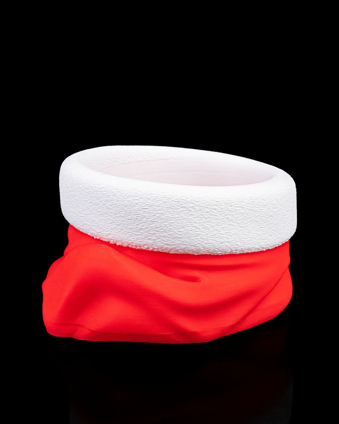 Santa hat candy bowl empty, front view, red hat with textured white brim and pom-pom, on black background