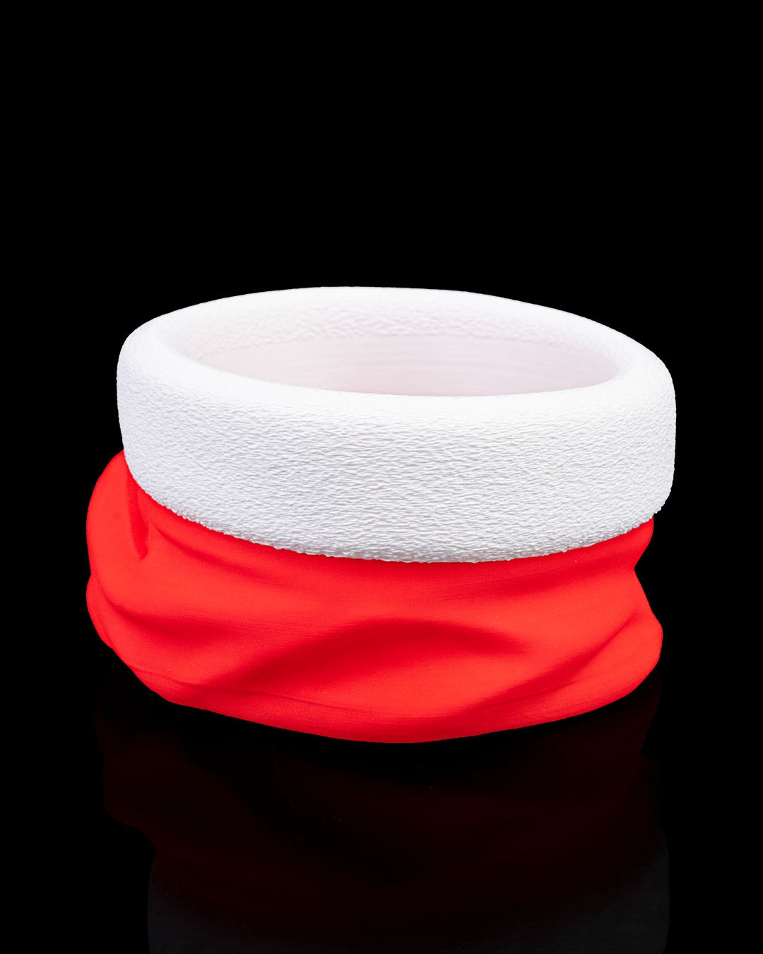 Santa hat candy bowl empty, alternate angle, red hat with textured white brim and pom-pom, on black background