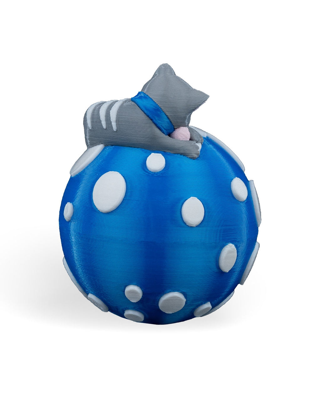 Sleeping Cat Christmas ornament turned to the side, showing the kitten's stripes and blue collar, on a white background
