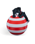 Sleeping Puppy Christmas ornament, 3D printed, front view: black puppy with a pink tongue asleep on a red-and-white striped ball, on a white background