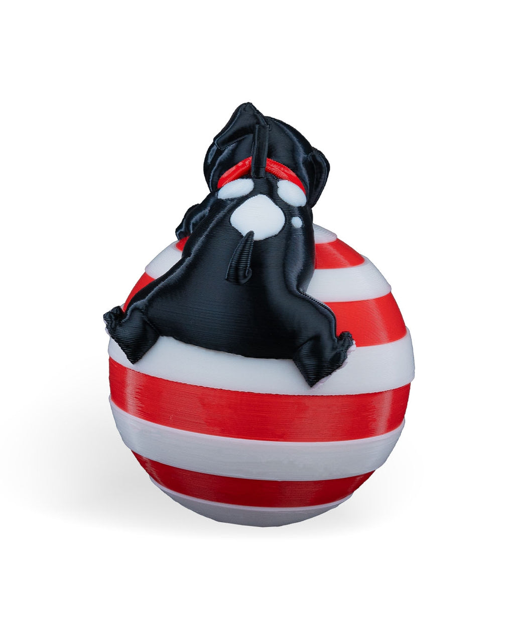 Back of the Sleeping Puppy Christmas ornament showing the black puppy draped over the striped ball, on a white background
