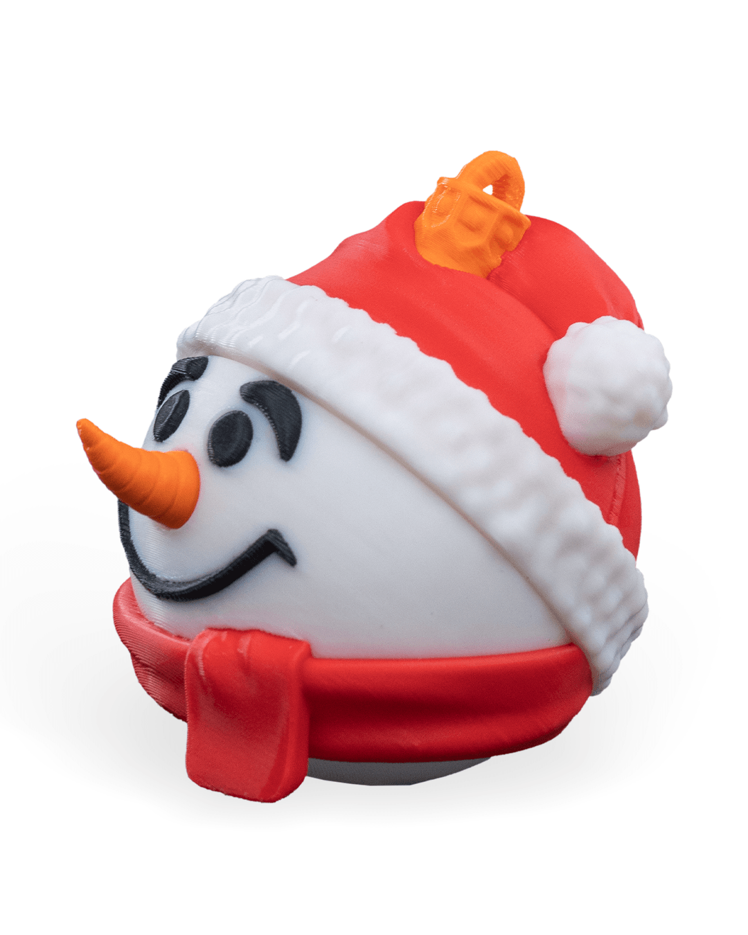 Snowman Christmas ornament turned to the left, showing the carrot nose, red hat pompom and red scarf, on a white background